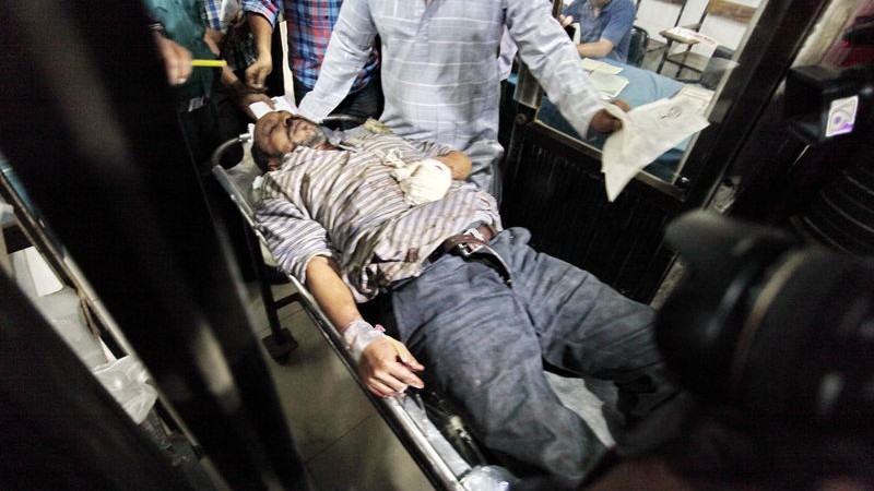 An injured blogger is being taken to the hospital. Extremists attacked three bloggers in the office of Shuddhoshor Publications in Dhaka, Bangladesh. Image by Khandaker Azizur Rahman. Copyright Demotix (31/10/2015)