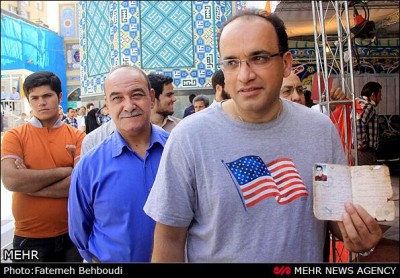 Man in a t-shirt featuring the US flag votes in Iran. From MEHR News