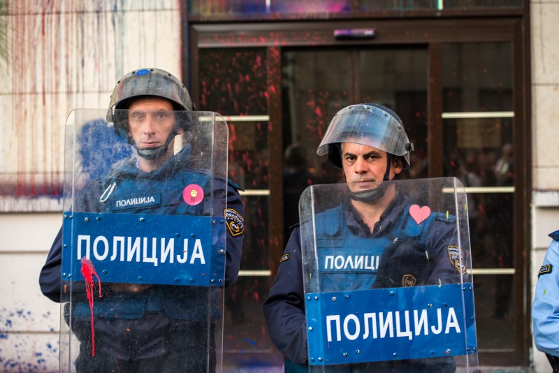 Colorful Revolution protesters place stickers with hearts on riot police shields upon close encounters. Photo by Vančo Džambaski, CC BY-NC-SA.