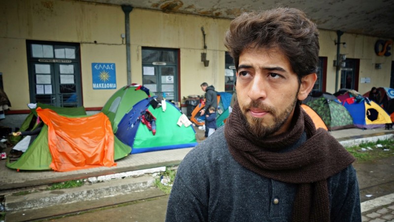 Ibrahim Esmael Ibrahim at the train station in Idomeni, Greece. As a teenager, he worked as a translator with the US military in Iraq. Credit: Filip Warwick. Used with PRI's permission