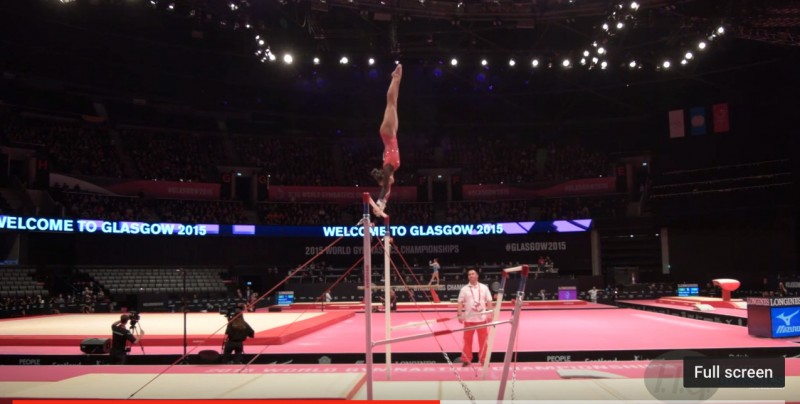 Screenshot of a YouTube video of gymnast Marisa Dick competing at the 2015 World Qualifications in the Uneven Bars. 