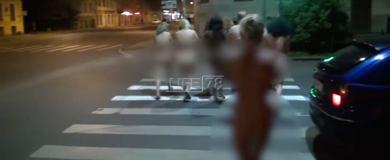 Women forced to walk nude through the streets en route to a police station. “Activists” captured them for practicing prostitution. Image: Life.ru