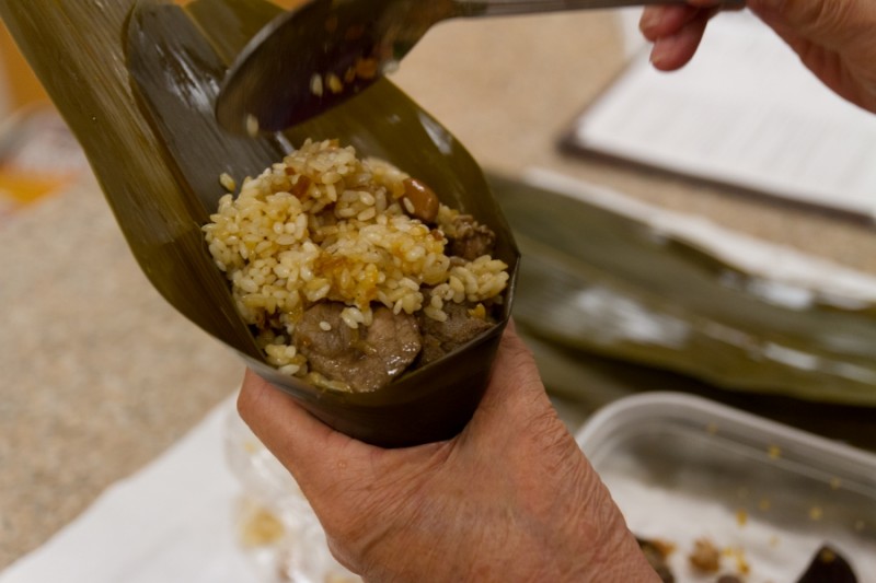 Yu fills the bamboo leaves with simple ingredients. They are often made with sticky rice, braised pork, shitake mushrooms, shallots and sometimes chest nuts or boiled eggs.