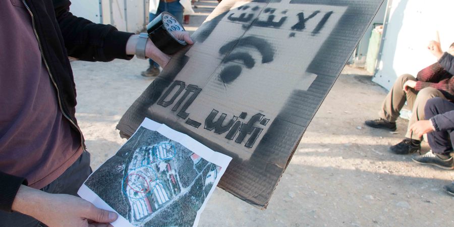 Disaster Tech Lab is a startup offering WiFi infrastructure building in disaster recovery areas and makeshift refugee camps. These were the signs being setup around the camp to indicate presence of internet connectivity. The map of hotspot locations is also visible. Mytilene, Moria camp, 29/12/2015. Source: http://digitalstain.org/2016/02/mytilene-part-two.html
