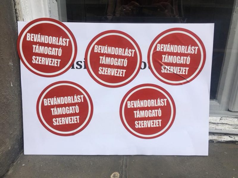 Stickers with the label “An organization that supports immigration” (“Bevándorlást támogató szervezet,” in Hungarian) put on the door of Hungarian Helsinki Committee office in Budapest on 27 June 2018 by ruling party members. Photo by HHC, used with permission.