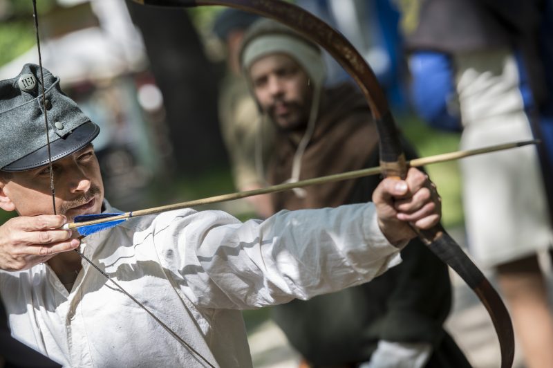 Man shooting an arrow with a bow.