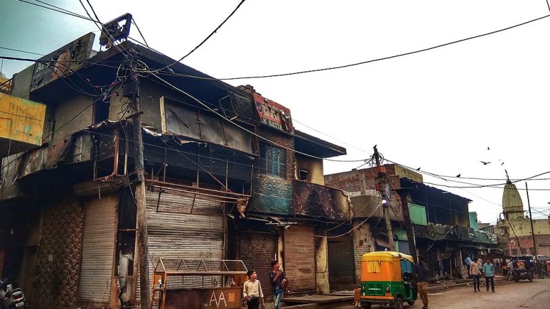 Burnt shops at Shiv Vihar, Delhi. Image by Banswalhemant via Wikimedia Commons. CC BY-SA 4.0