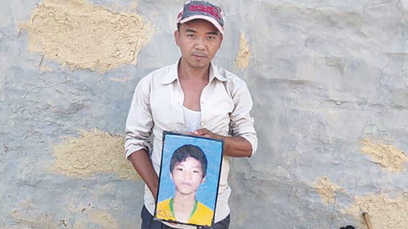 Bhojbahadur Layomagar with a picture of his nephew Sushil Layomagar