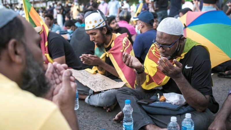 April 9th - With placards for tablemats, Muslim protesters prepare to break fast on the Galle Road under the cover of a light drizzle